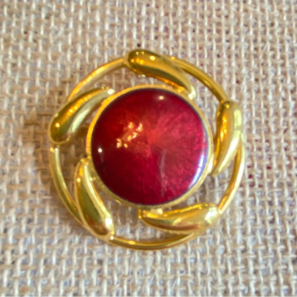 Convertible brooch and pendant circle with red enamel center in goldtone metal